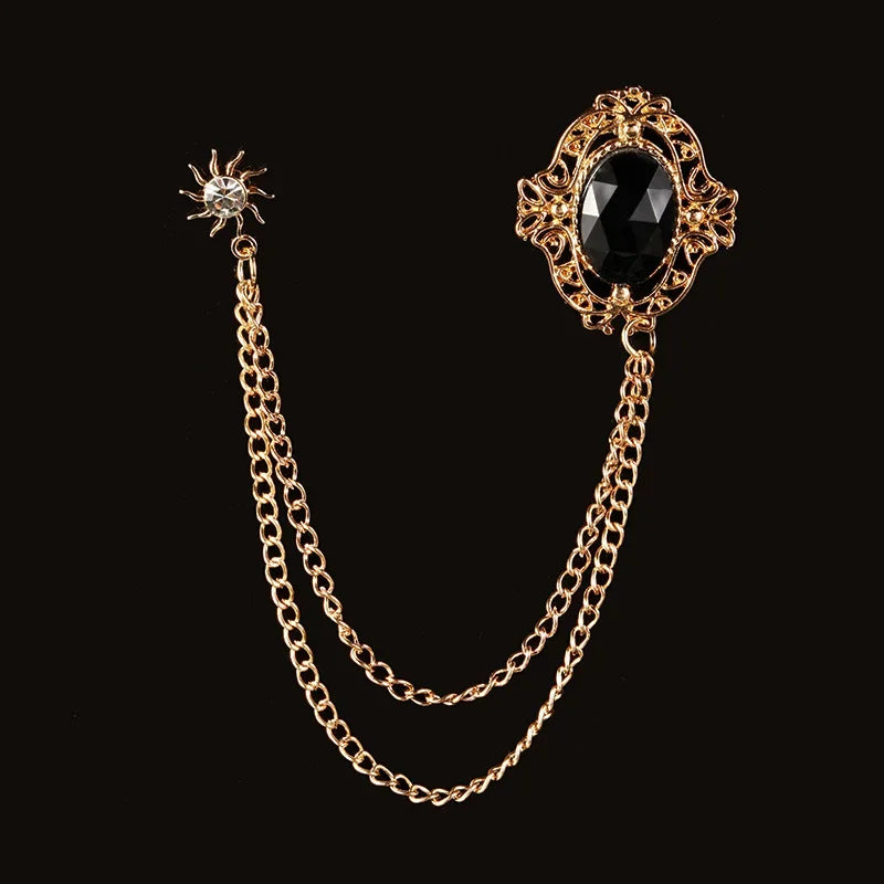 Vintage gold brooch with black gemstone and elegant chain