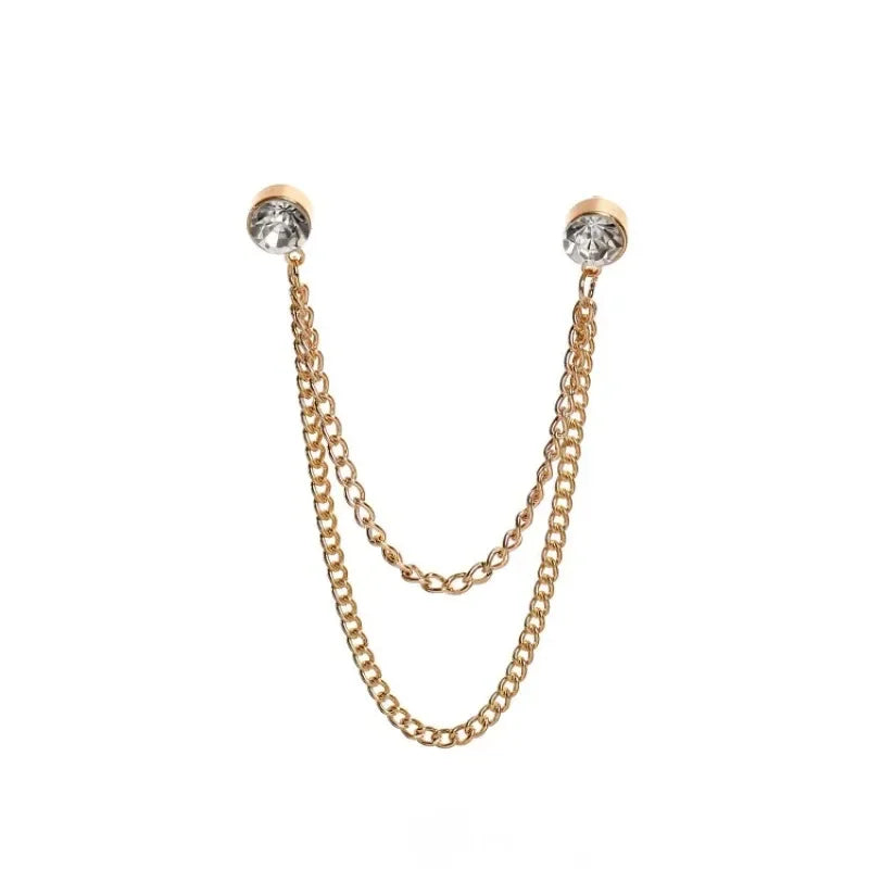 Gold chain brooch with crystal studs on white background
