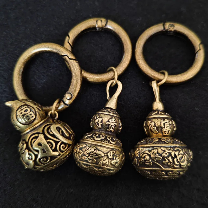 Vintage brass gourd keychain with engraved Sanskrit pattern and antique finish