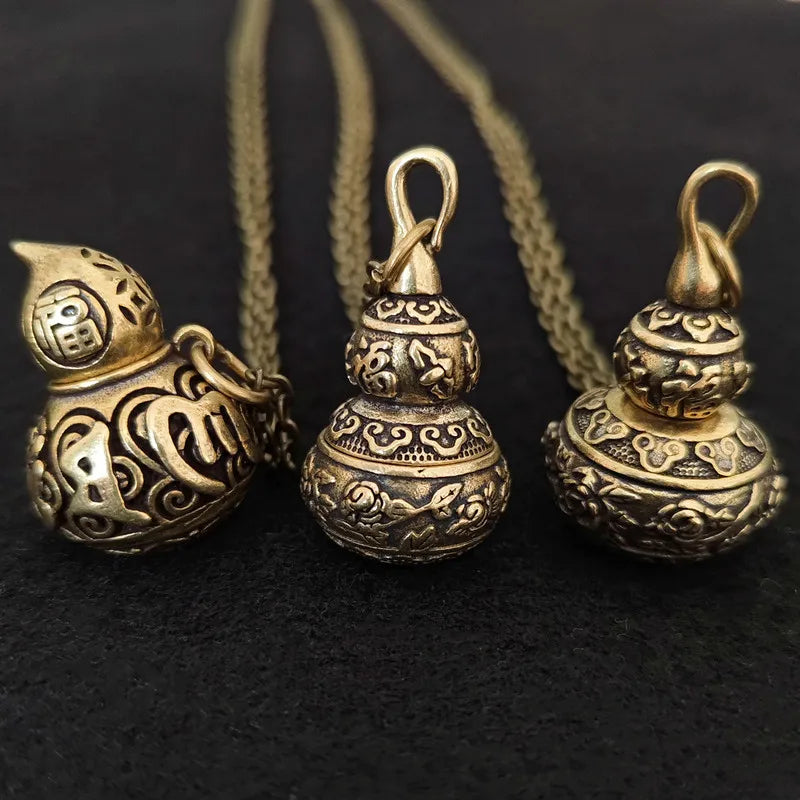 Set of vintage brass gourd pendants featuring decorative Eastern-inspired designs