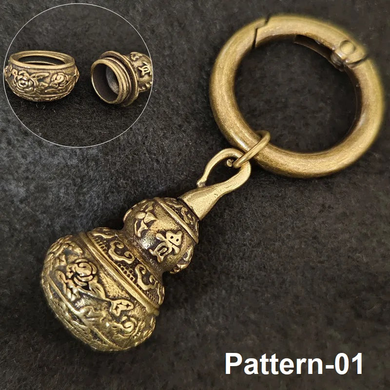 Antique brass keychain pendant with detailed floral and Sanskrit-style engraving