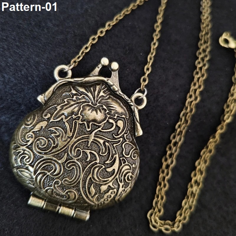 An ornate antique-style metal purse-shaped pendant necklace with intricate floral and scroll engravings, shown on a dark textured background with part of the chain visible. The text 'Pattern-01' appears in the top-left corner.