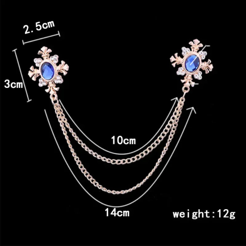 cross brooch with snowflake design and chain, shown with measurements on a black background