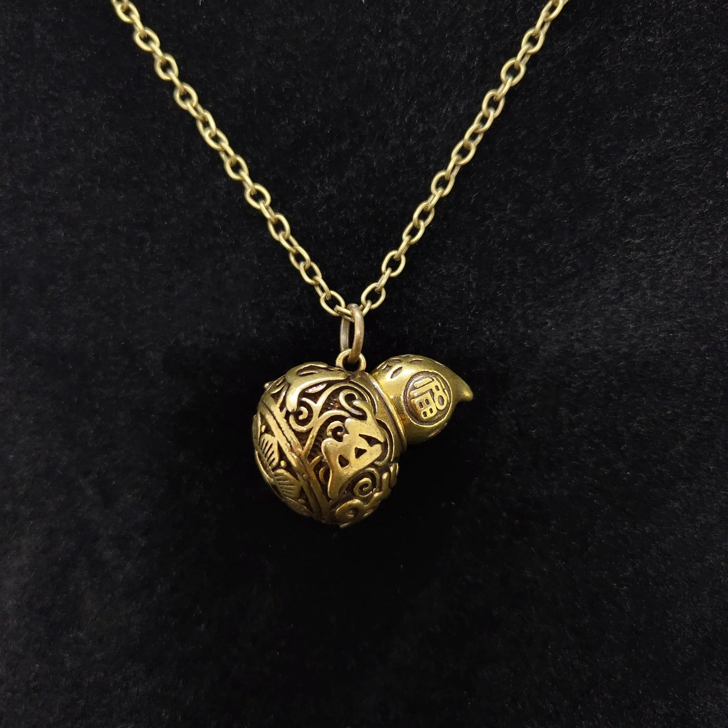 Antique copper alloy gourd urn pendant necklace featuring secret storage compartment and vintage floral  