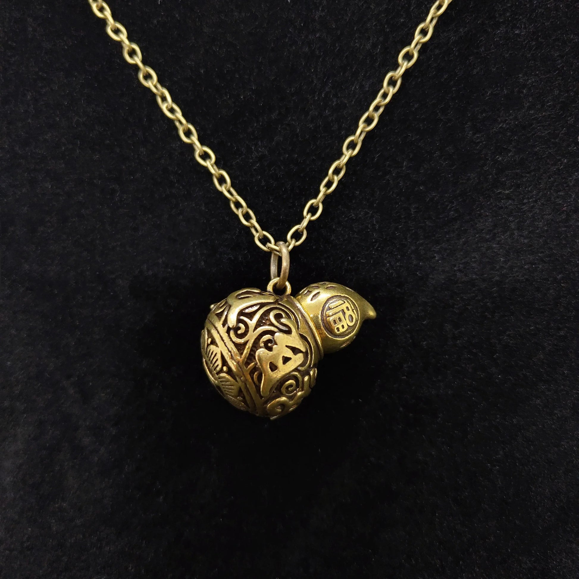 Antique copper alloy gourd urn pendant necklace featuring secret storage compartment and vintage floral  