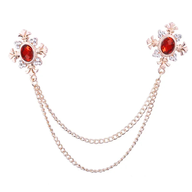 Gold Red Crystal cross chain brooch pins with gemstone accents on white background.