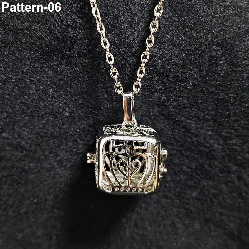 Silver pendant necklace with intricate design on a dark background