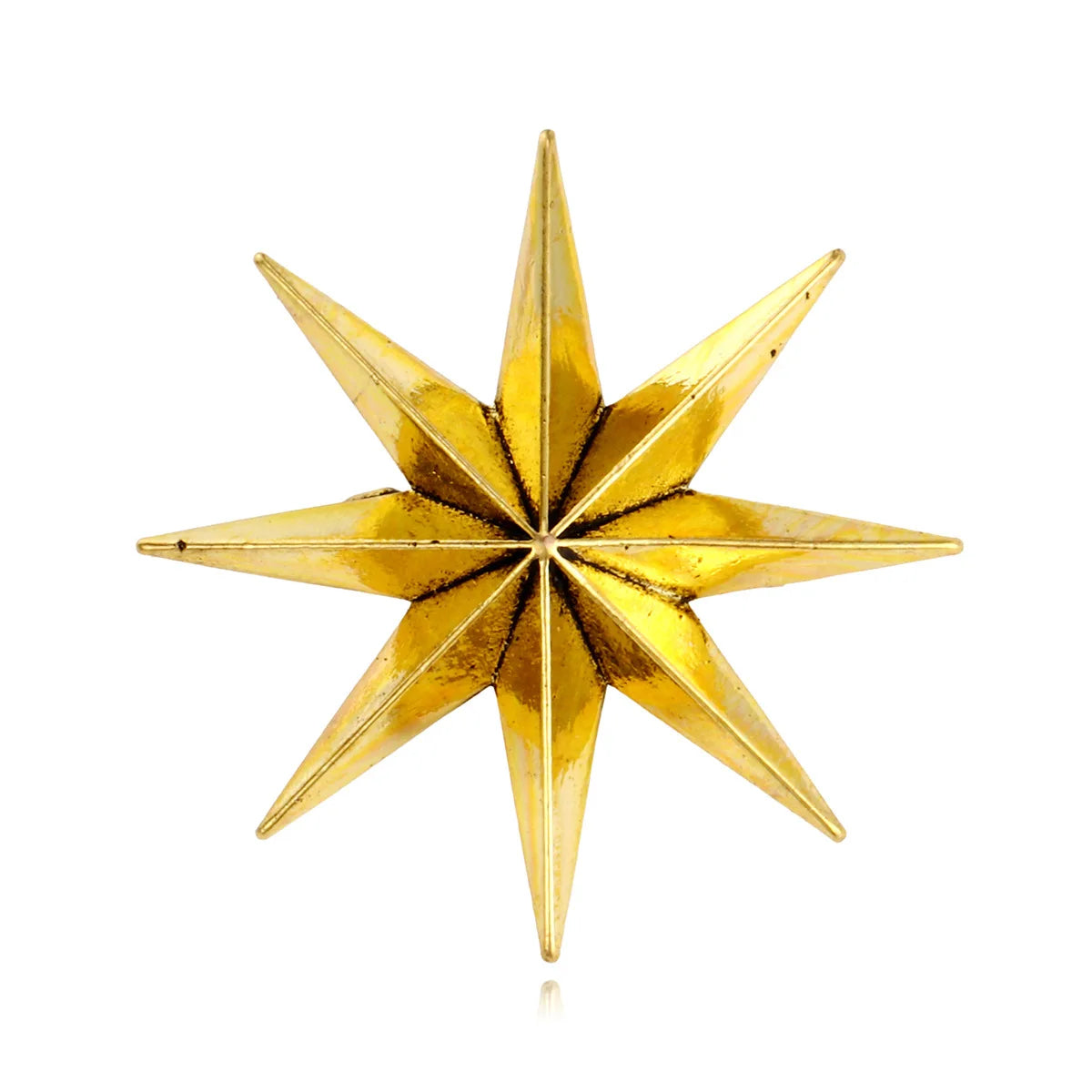 Shiny gold star fashion brooch on plain white background