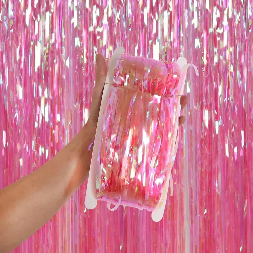 Clear plastic bag with pink tinsel against a pink tinsel curtain background