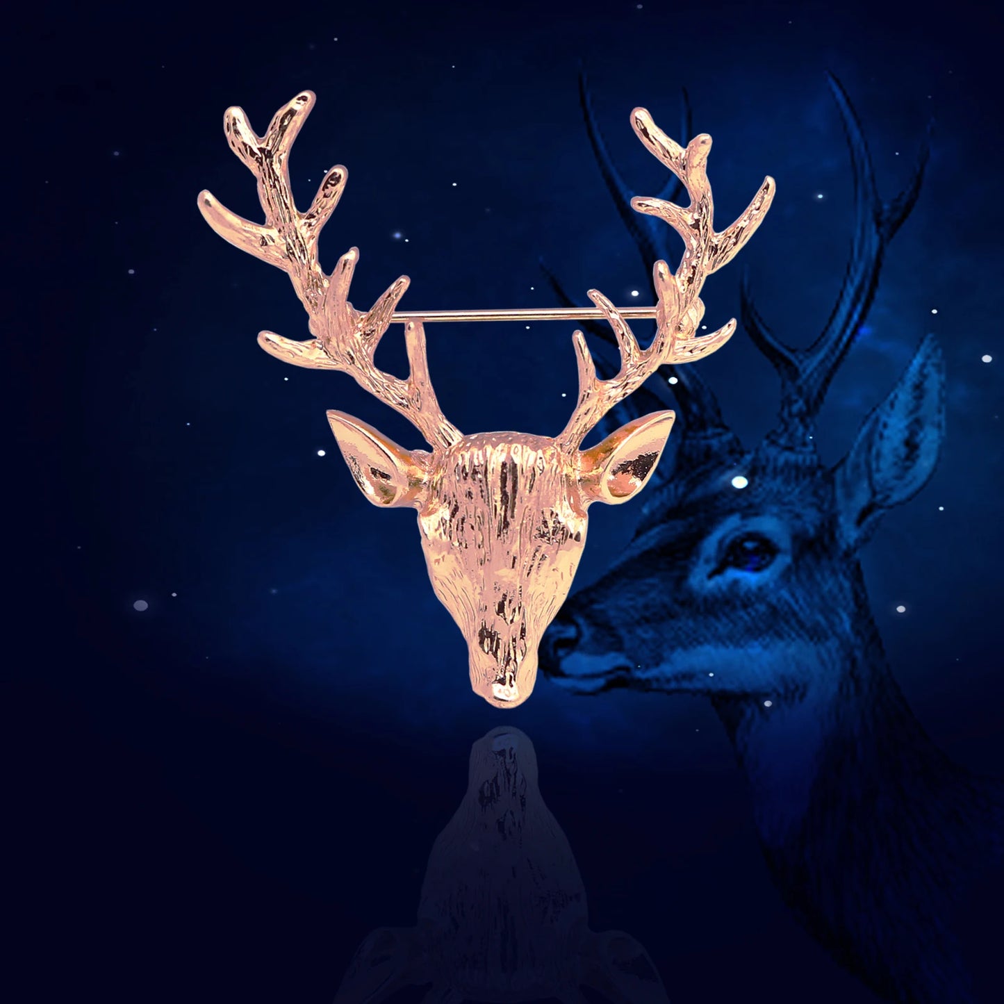 Gold deer head brooch on a dark background