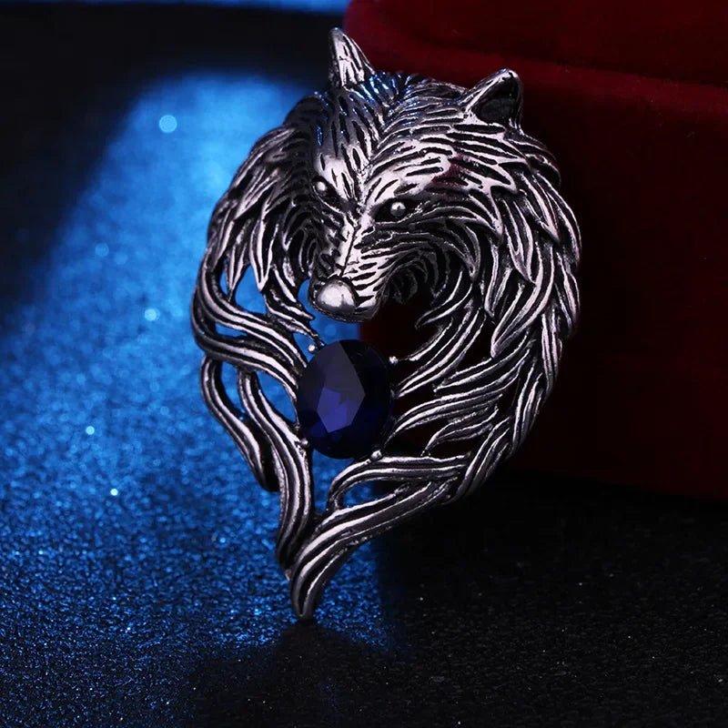 Silver wolf head lapel pin displayed on dark background